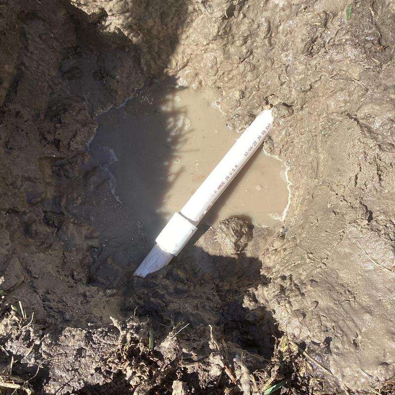 PVC water meter pipe leak in muddy ground