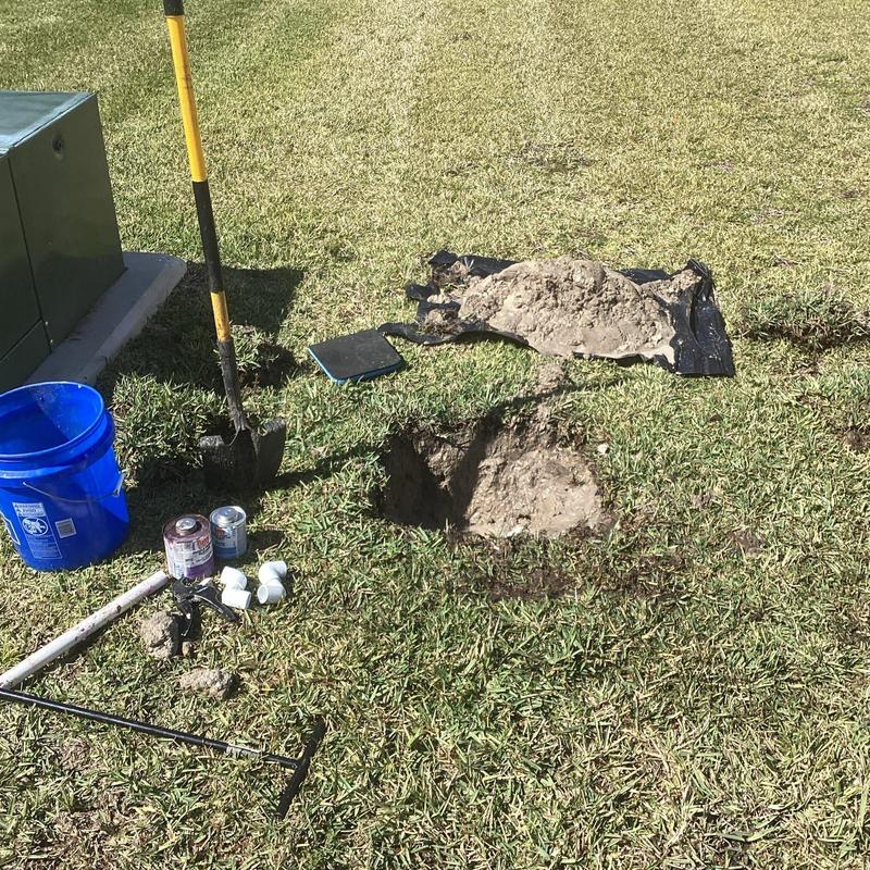 Water meter leak repair site with tools and PVC fittings