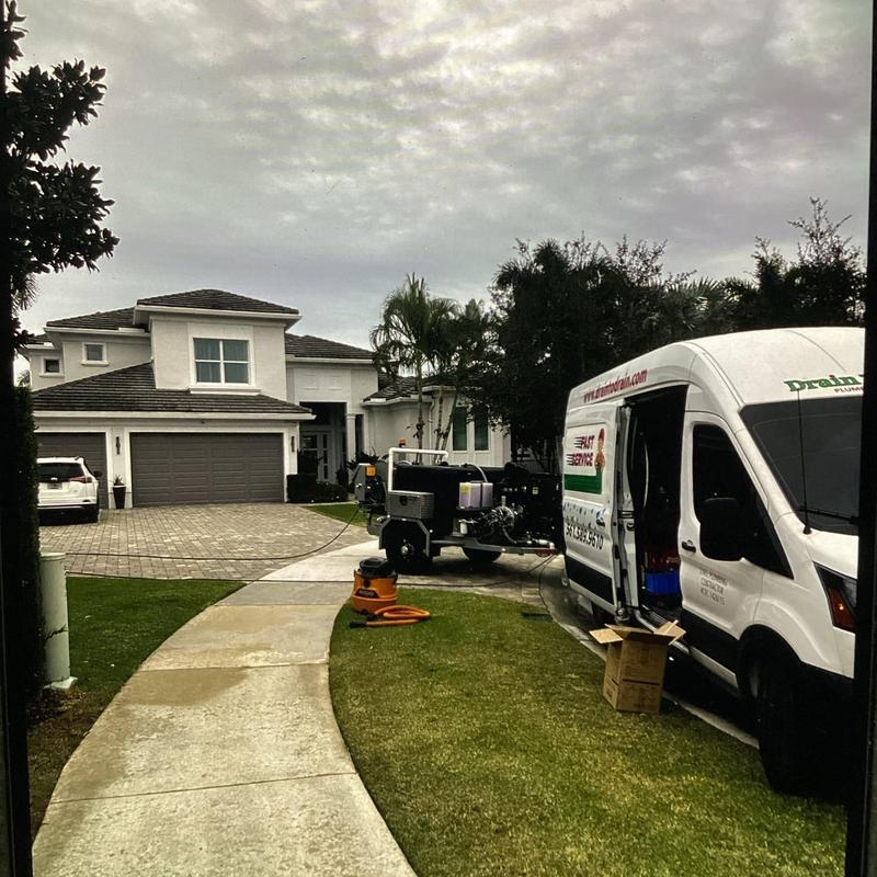 Residential hydro jetting equipment setup near driveway
