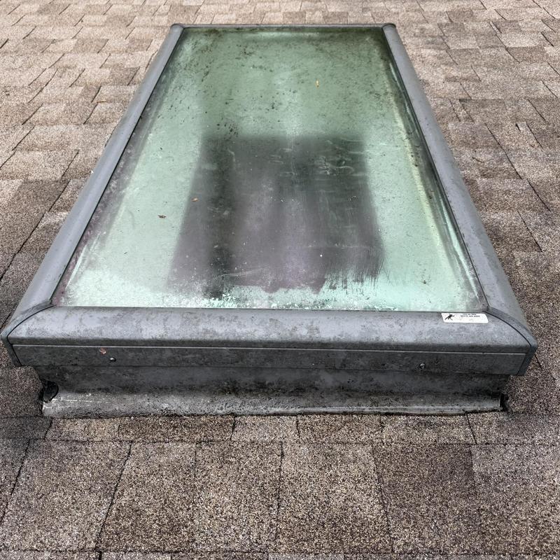 Skylight with metal frame on shingle roof