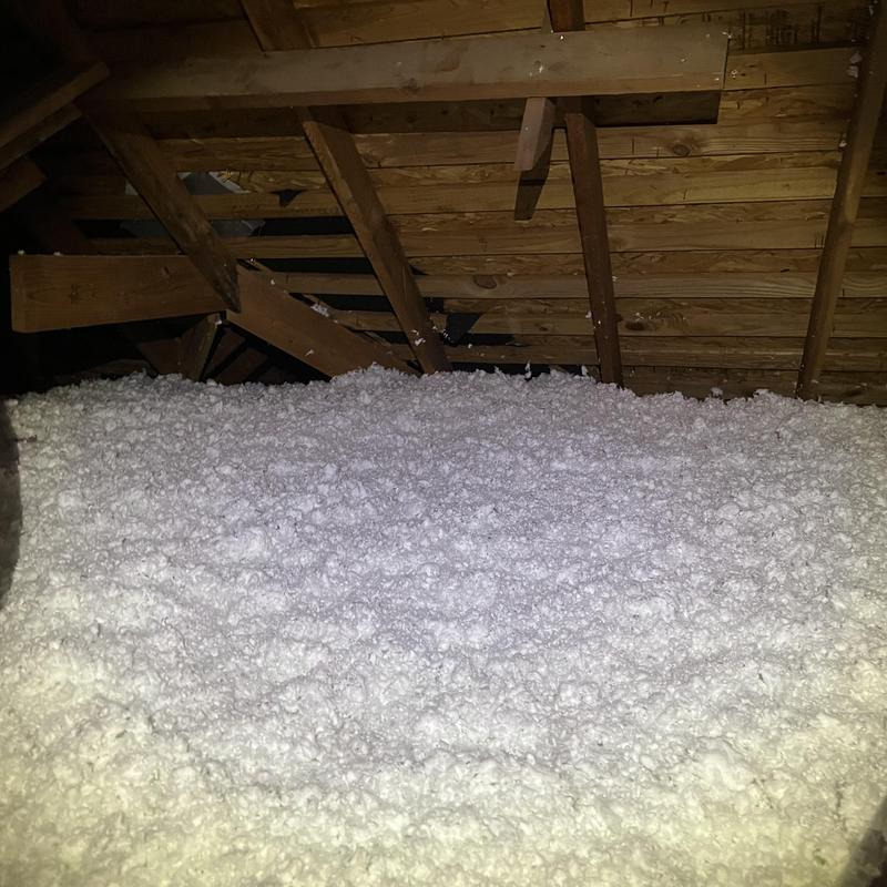 Attic loose-fill insulation installed under roof rafters