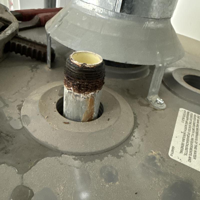 Water heater galvanized nipple installation close-up