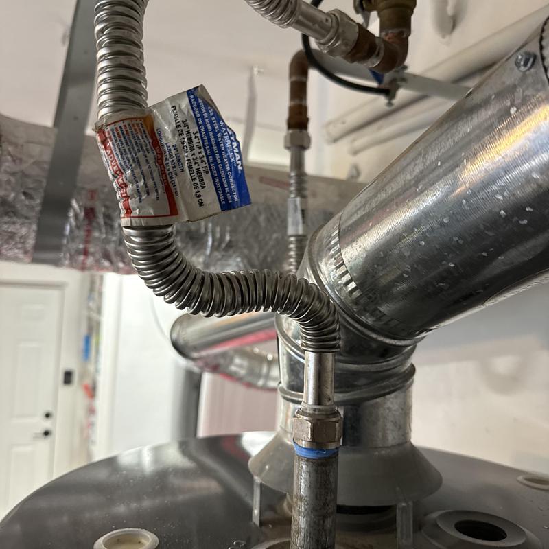 Water heater flexible gas line and vent pipe installation