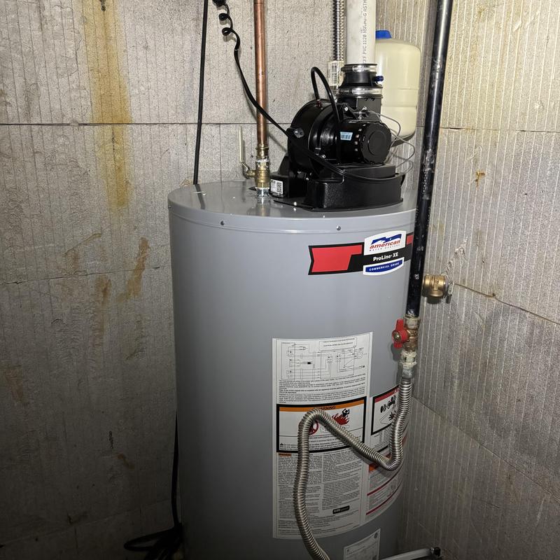 Water heater with ventilation fan installed in basement
