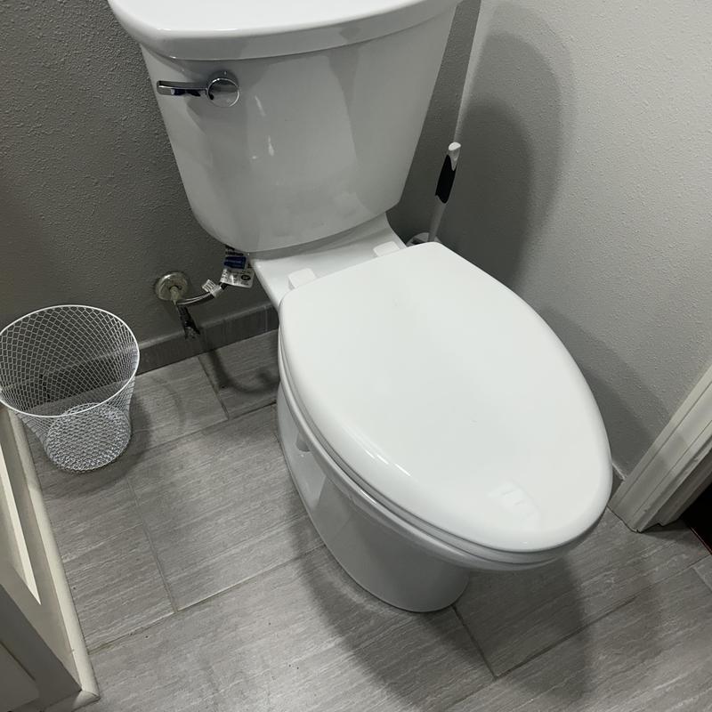 Toilet comfort height installation in bathroom corner