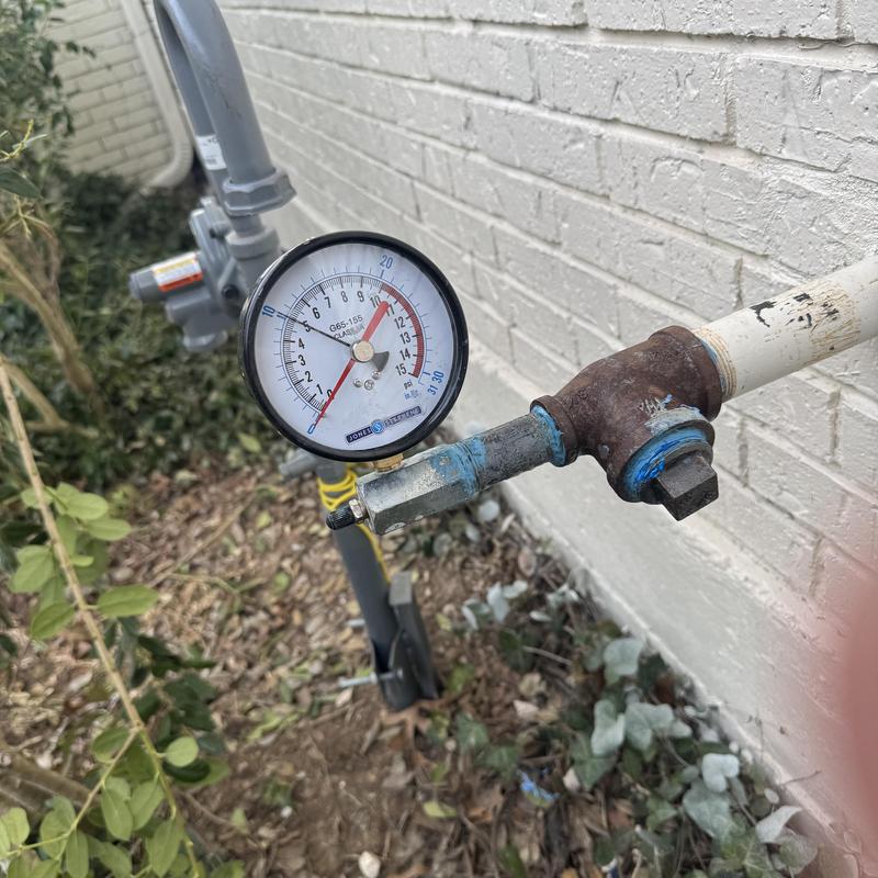 Gas pressure gauge on outdoor pipe fitting