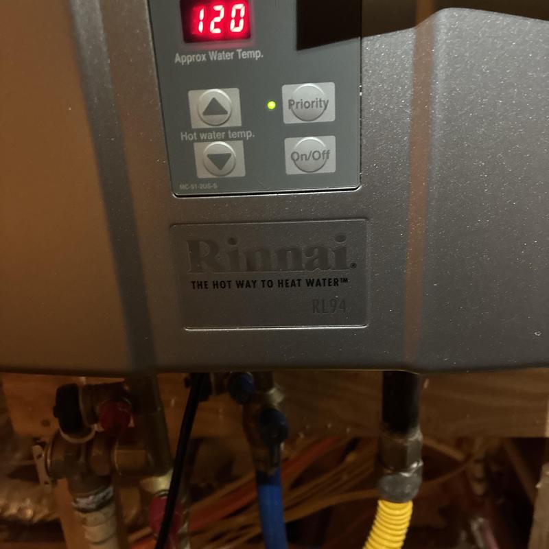 Tankless water heater control panel set to 120°F
