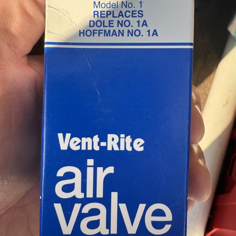 Steam radiator Vent-Rite air valve box held in hand