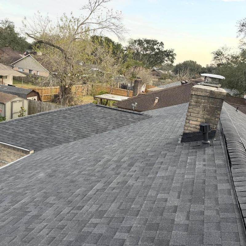 Asphalt shingle roof with chimney and vent pipes