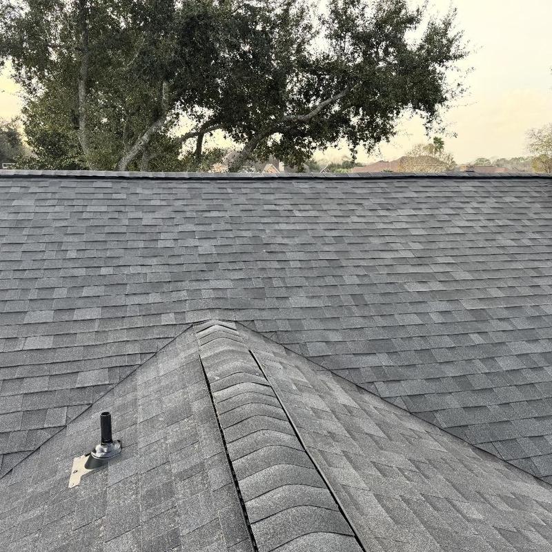 Asphalt shingle roof with ridge vent and vent pipe