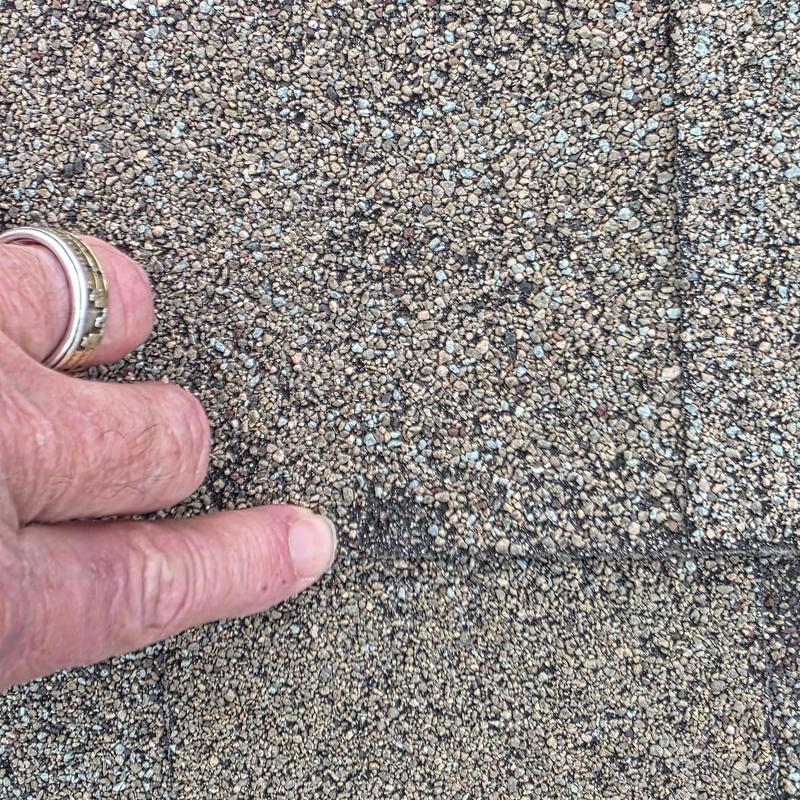 Asphalt shingle roof showing hail damage close-up