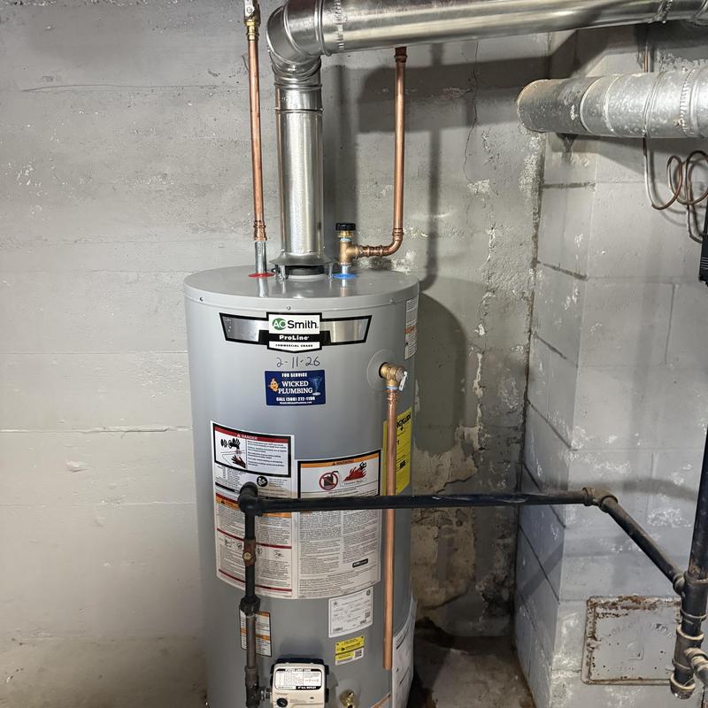 Water heater with connected copper and black piping Water heater with connected copper and black piping