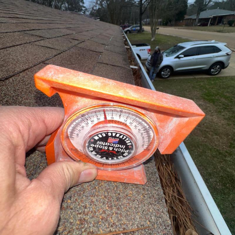 Roof pitch measurement with protractor on shingles Roof pitch measurement with protractor on shingles