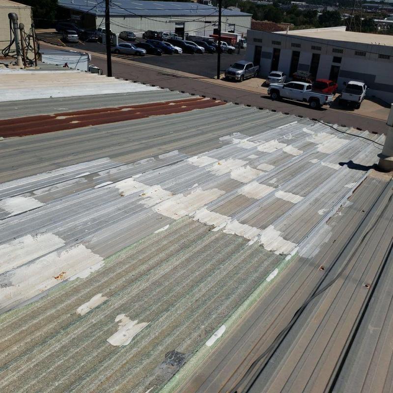 Metal pro-panel roof with rust and patch repairs Metal pro-panel roof with rust and patch repairs