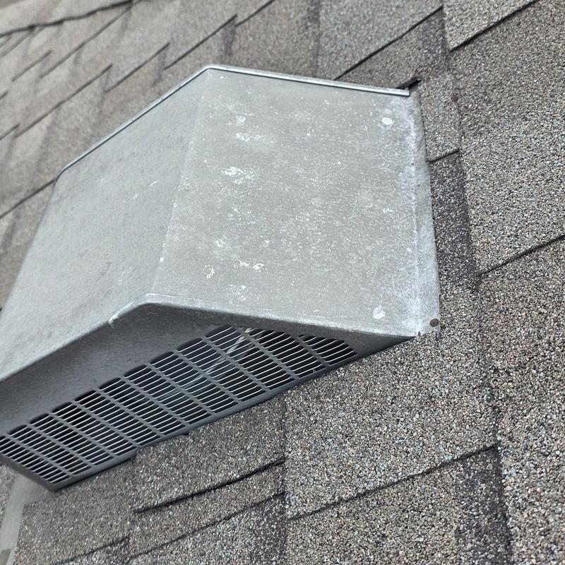 Roof vent with hail and wind damage on shingles