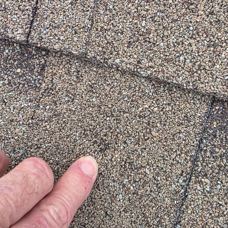 Asphalt shingle roof close-up with hail damage marks