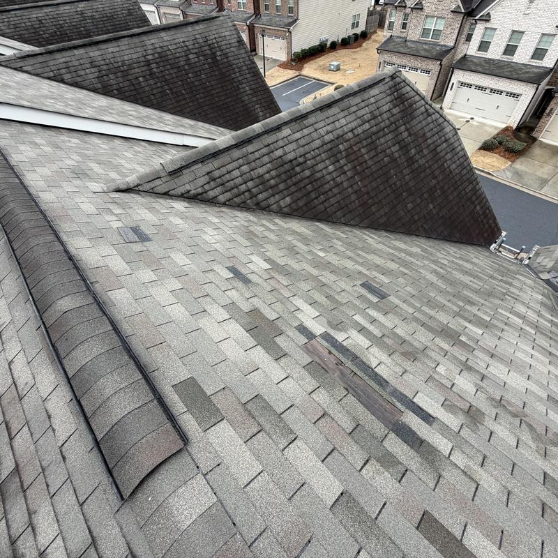 Roof shingles with missing sections and tarp installed