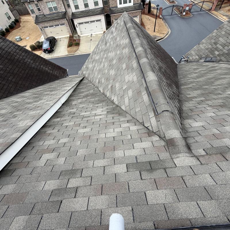 Three-tab shingle roof with taped exposed underlayment