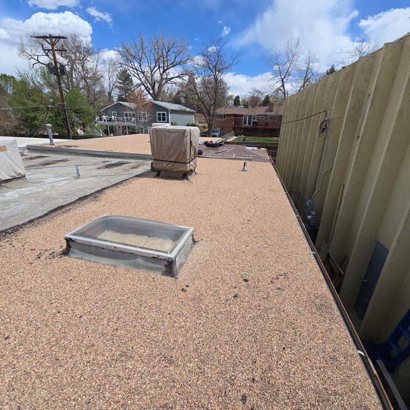 Tar and gravel flat roof showing wear and aging Tar and gravel flat roof showing wear and aging