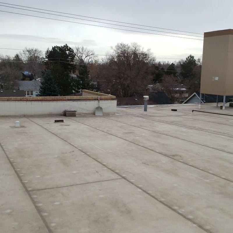 PVC flat roof with visible aging cracks and seams PVC flat roof with visible aging cracks and seams