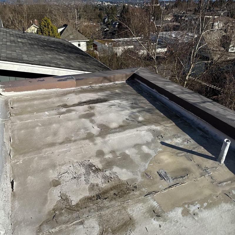 Flat roof membrane with wear and damage signs