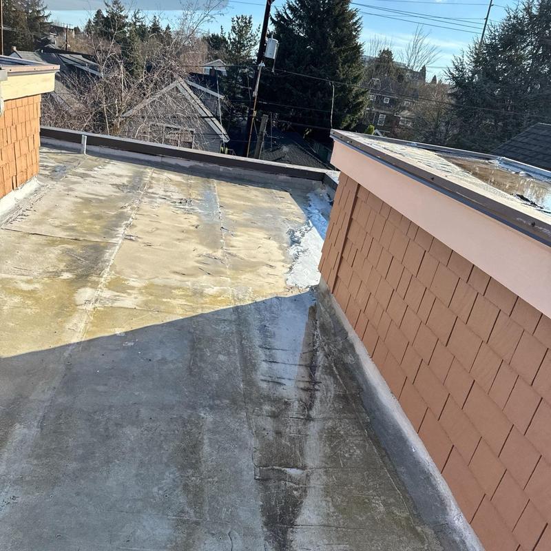 Flat roof surface with visible wear and discoloration