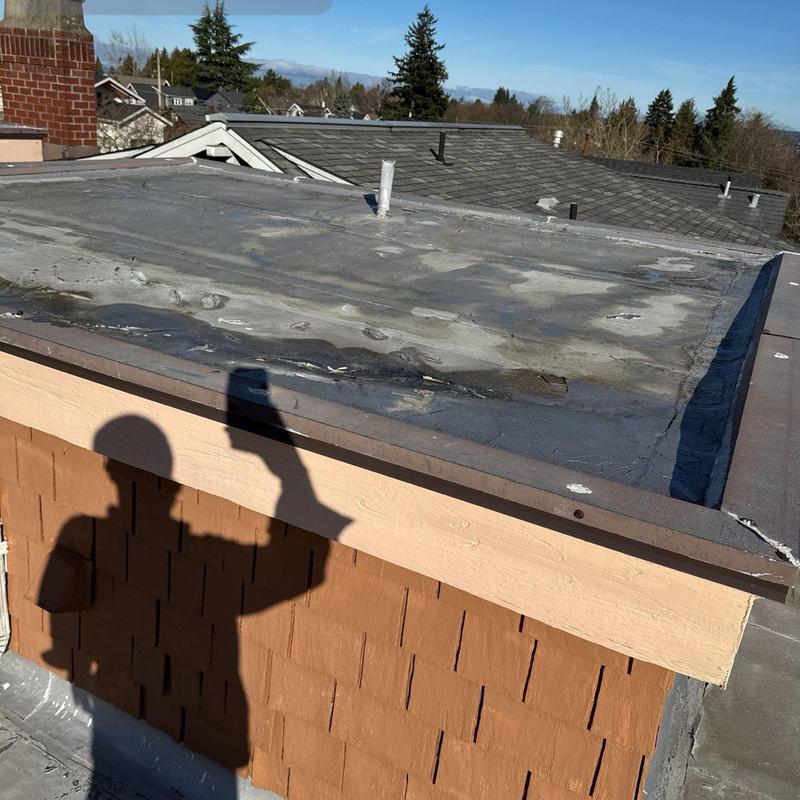 Flat roof surface with visible wear and damage inspection