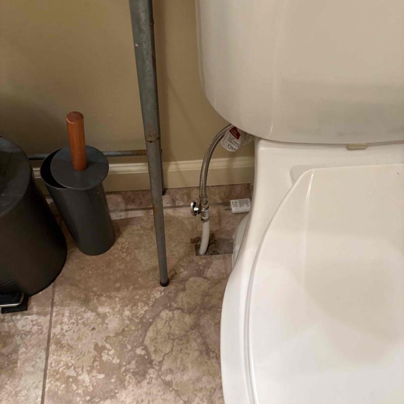 Toilet water supply line repipe near floor tile in bathroom