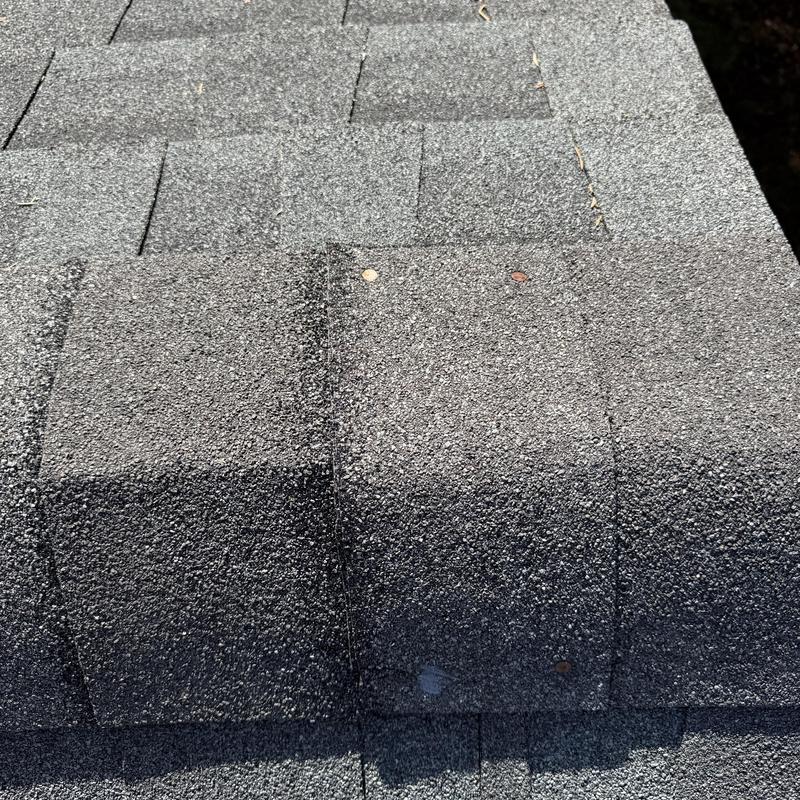 Asphalt ridge cap shingles with sealed nails on charcoal roof