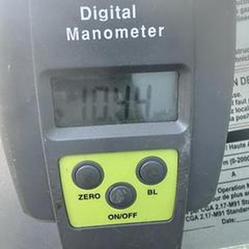 Digital manometer showing gas pressure at 10.44 WC