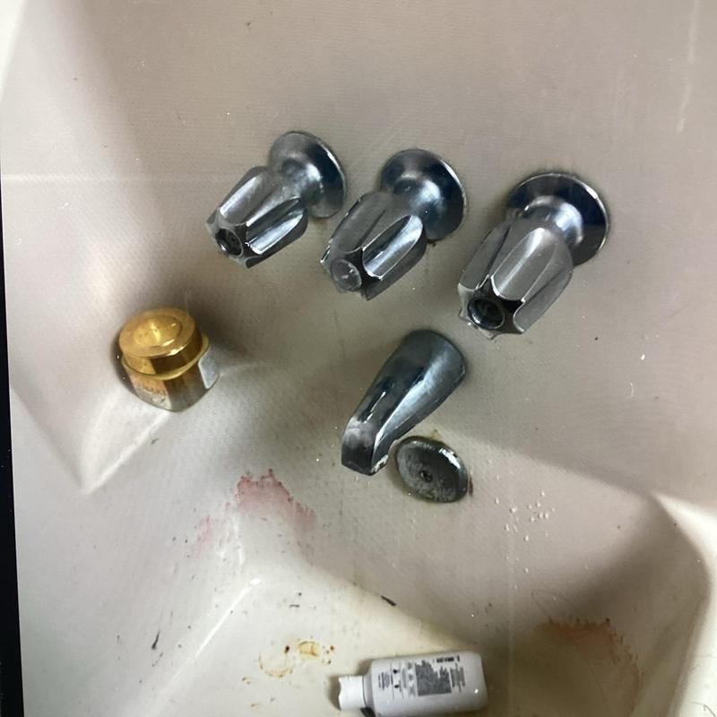 Faucet cartridges and spout removed for rebuild