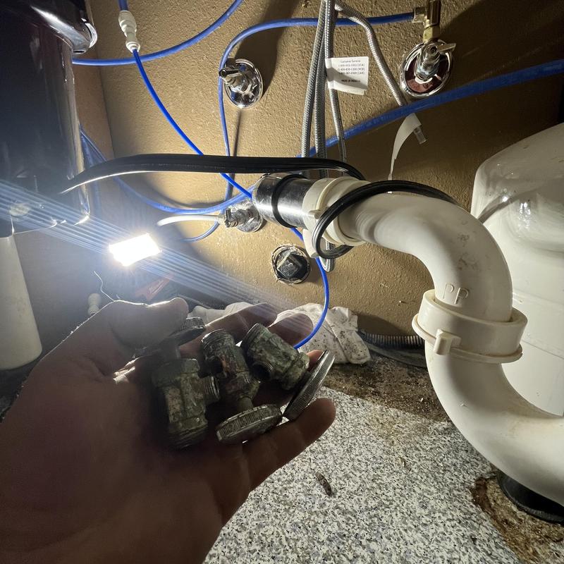 Angle stop valves held near plumbing under sink in Orcutt, CA