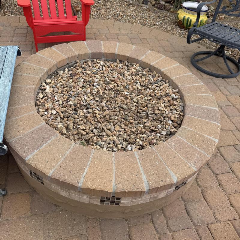 Fire pit with gravel fill on brick patio