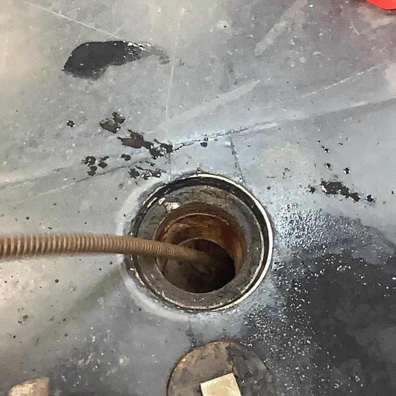 Main sewer line cleaning snake in drain pipe