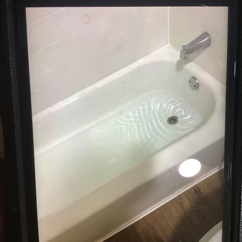 Bathtub drain with flowing water and faucet