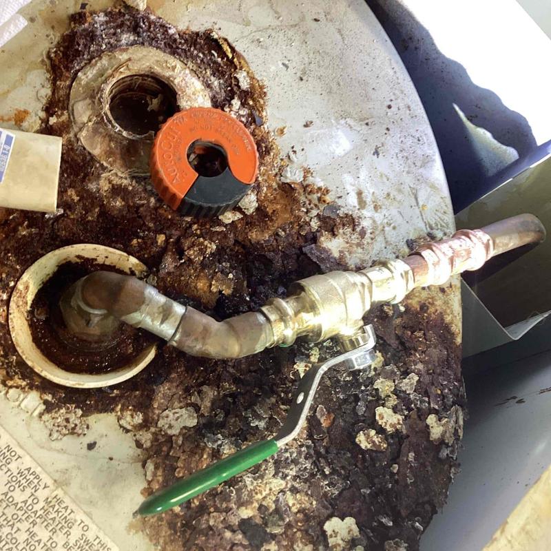Hot water heater pipe and valve with rust damage
