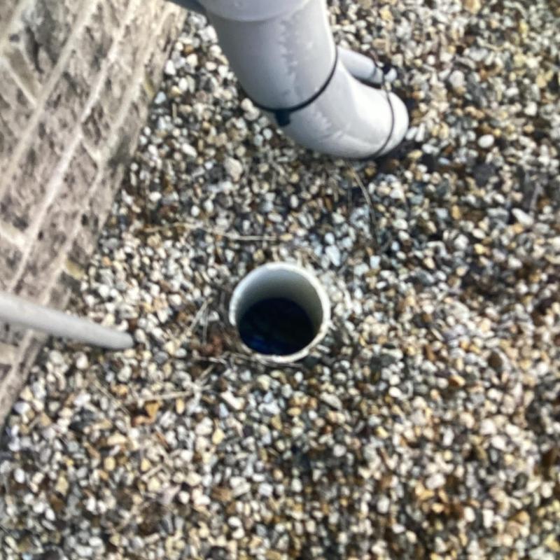 Sewer cleanout pipe access outside brick building