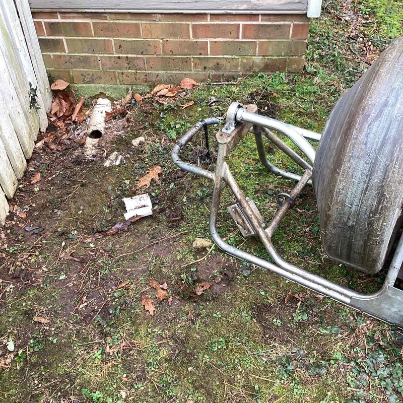 Underground drain pipe access hole with inspection camera reel