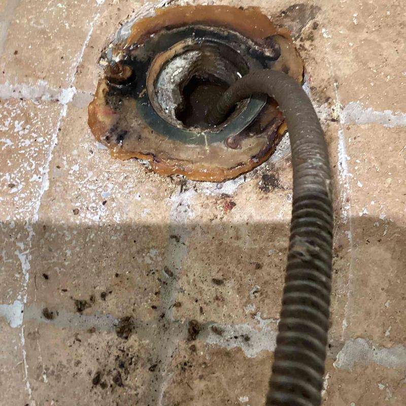 Mainline cable access with plumbing snake in floor drain