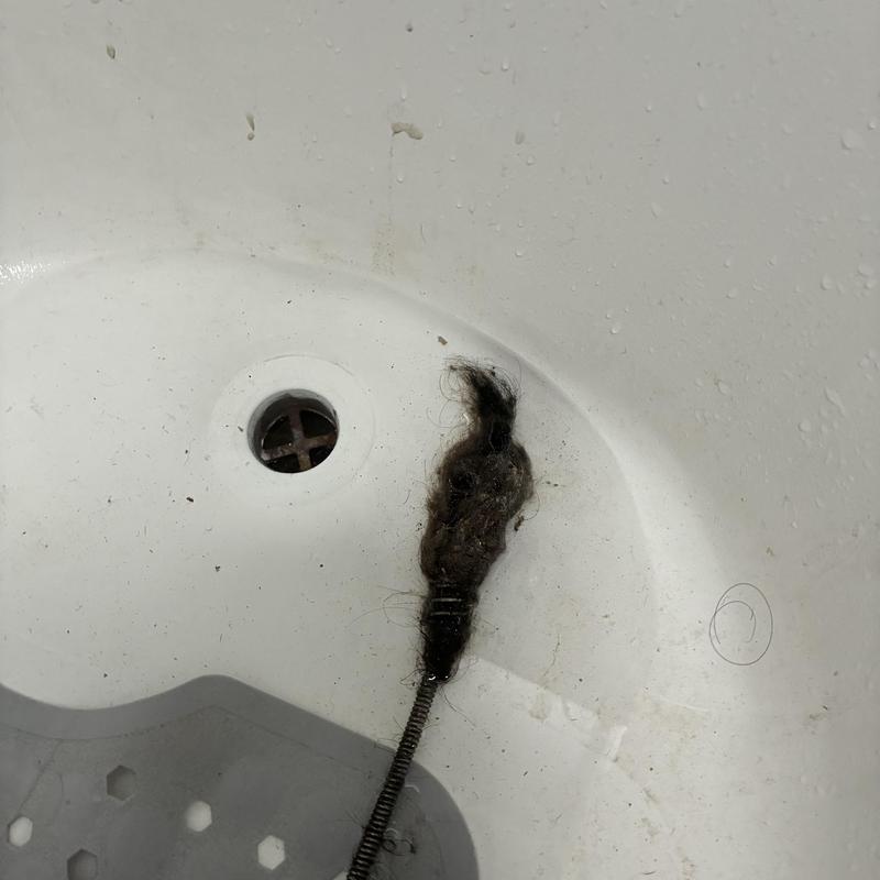 Bathtub drain clogged with hair blockage removal tool