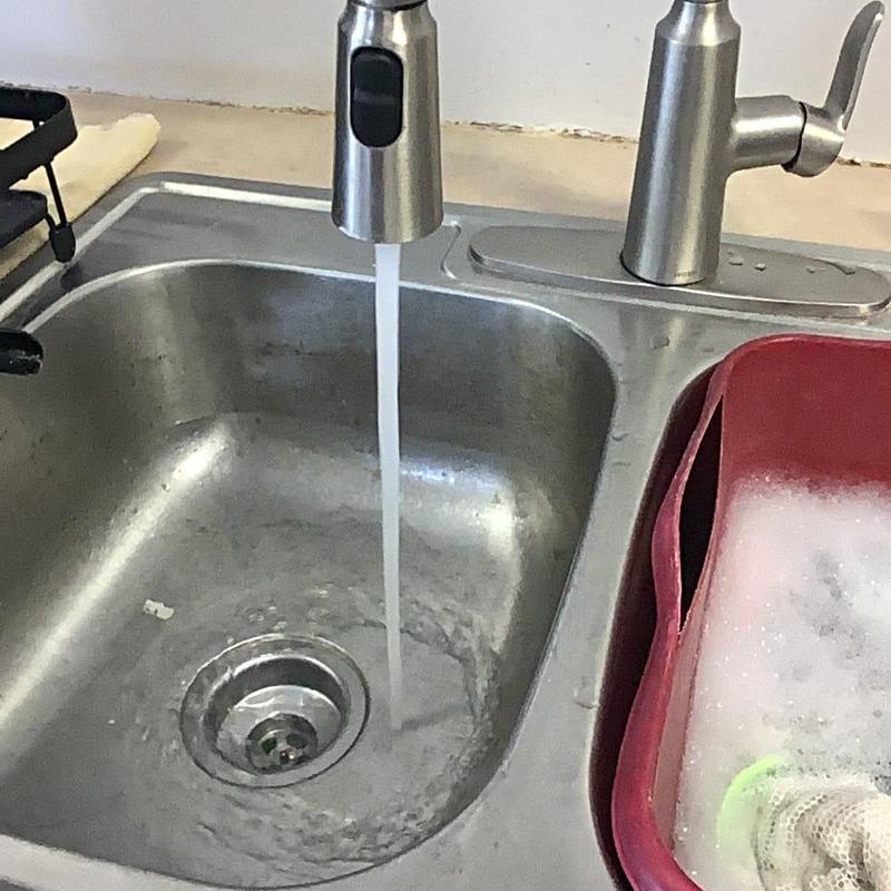 Kitchen sink drain with running water and soap basin