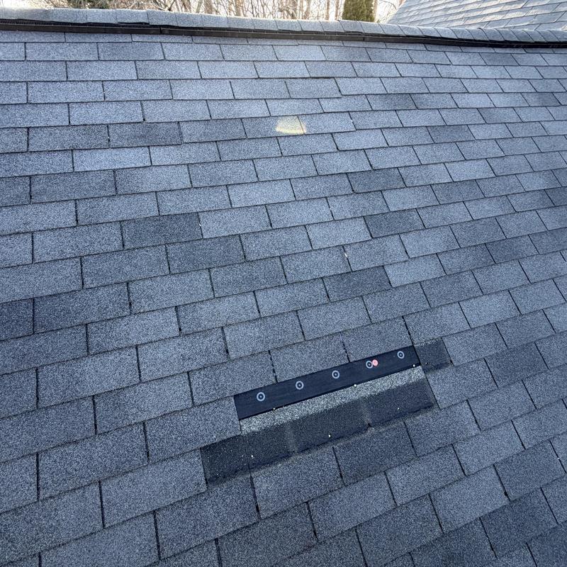 3-tab charcoal shingles with replacement patch on roof