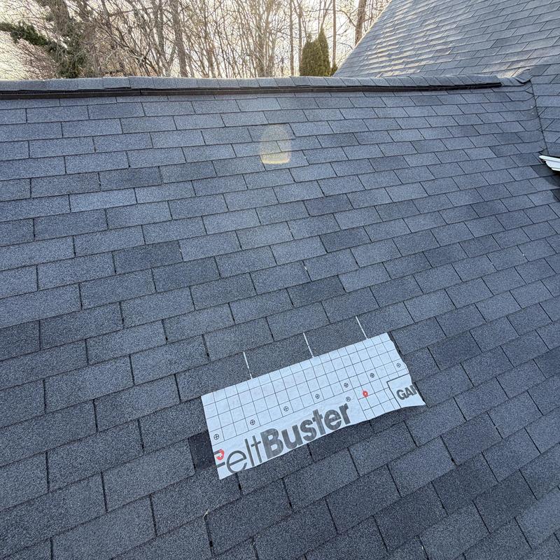 Charcoal 3-tab roof with tarp over missing shingles