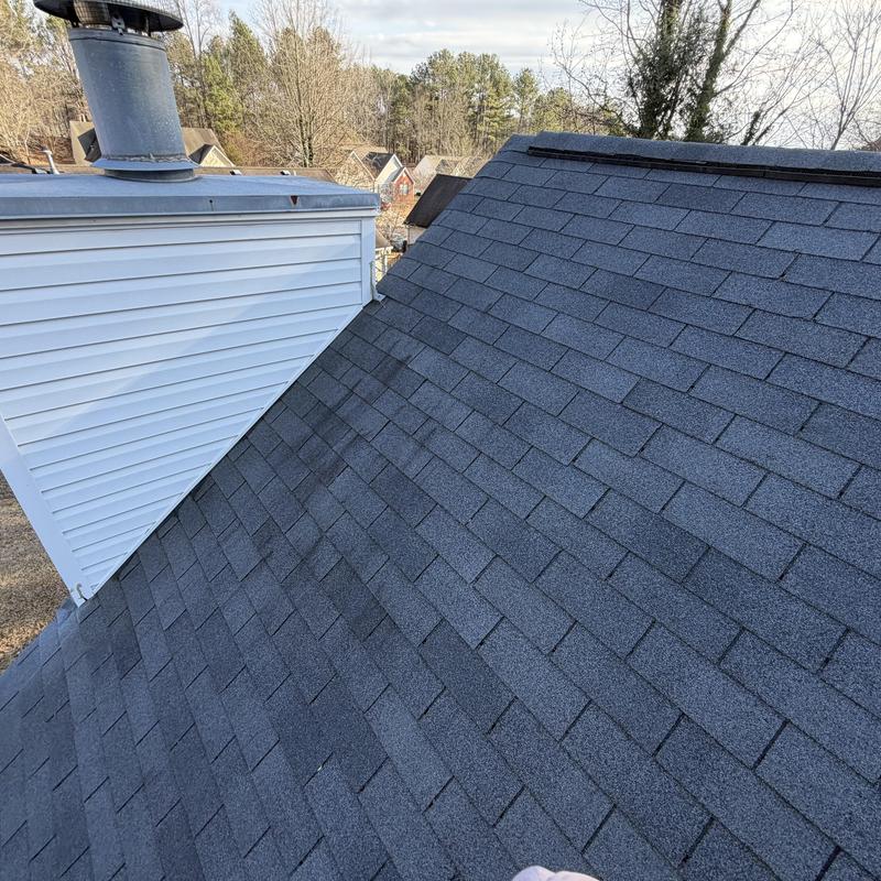 Charcoal 3-tab roof with small tarp over missing shingles