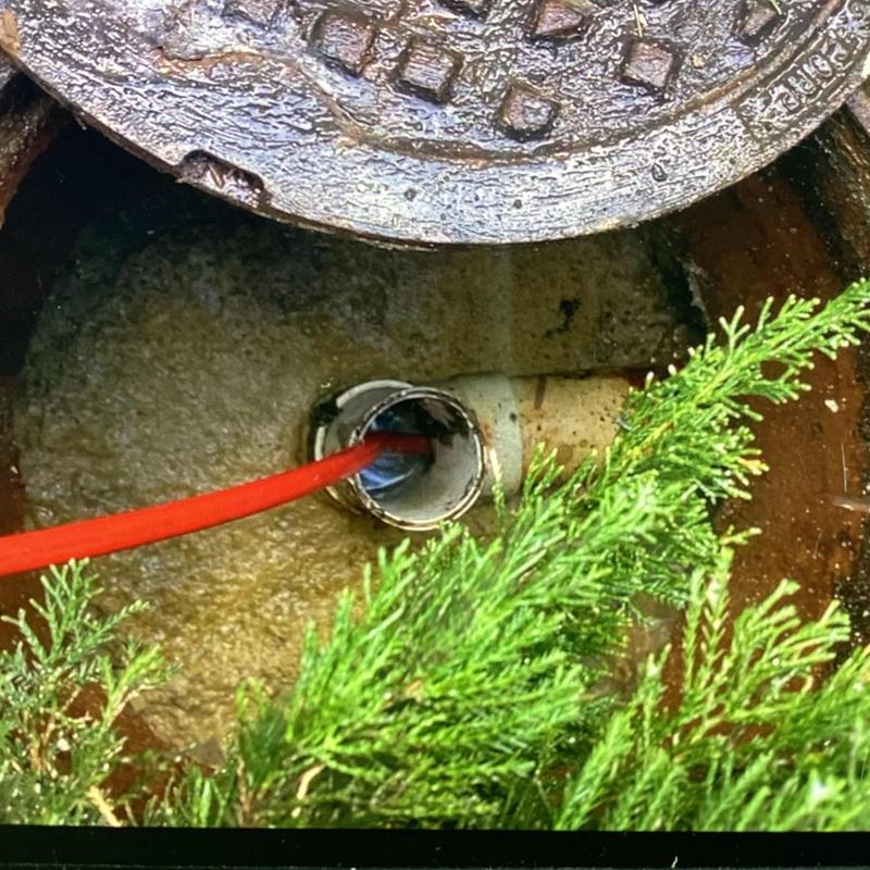 Grease trap line with jetting hose and open manhole