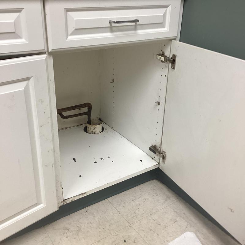 Kitchen sink drain pipe and cabinet interior