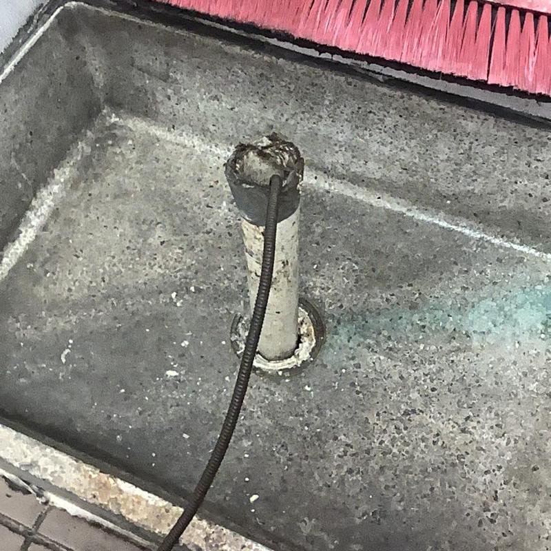 Main sewer line snake cleaning in floor drain