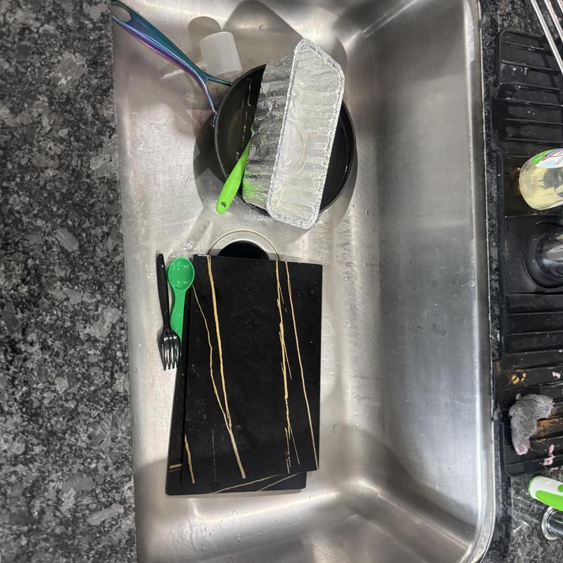 Kitchen sink with dishes and utensils inside