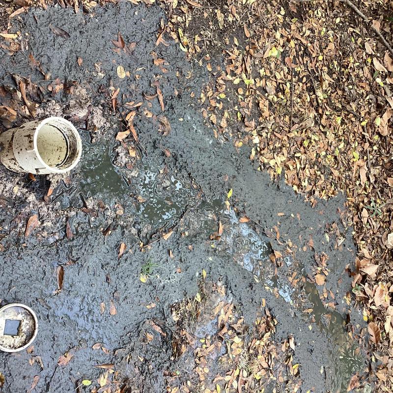 Sewer drainpipe with surface water and mud buildup