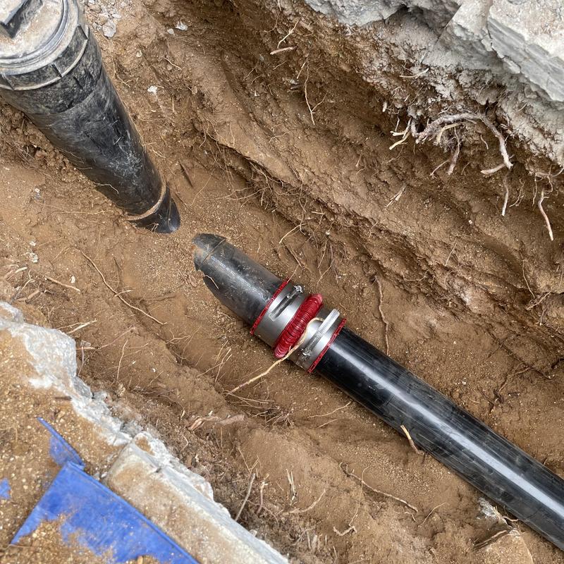 Sewer drain line with coupling installation in trench